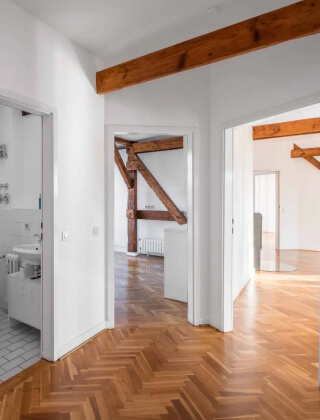 true form construction room with wooden floors and white walls creating a clean and natural ambiance