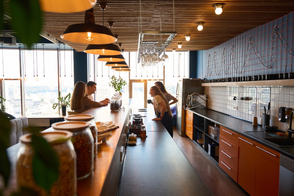 Three women and man gathered at the bar for communication